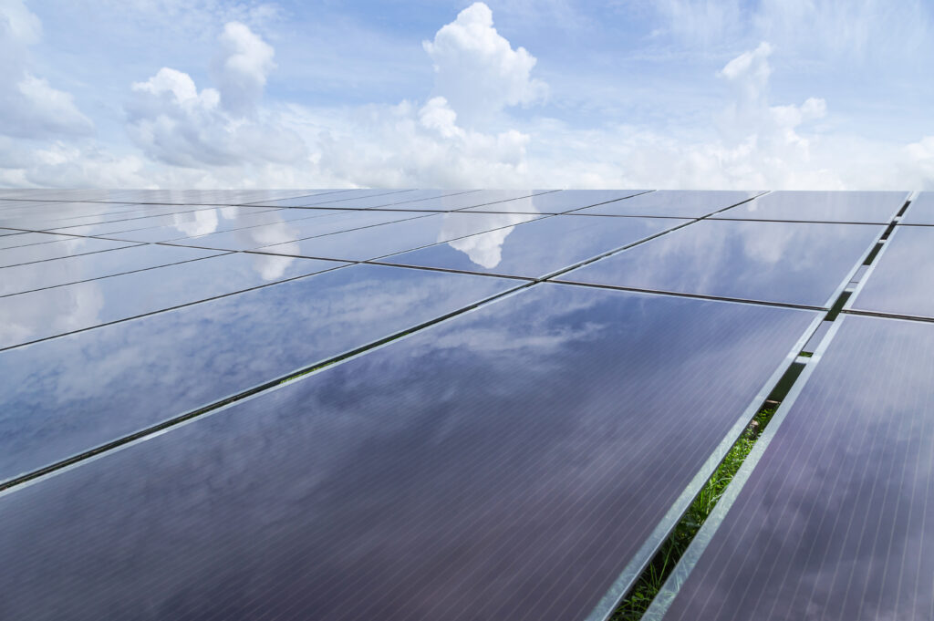 Thin-film solar panels reflecting clouds and sunlight