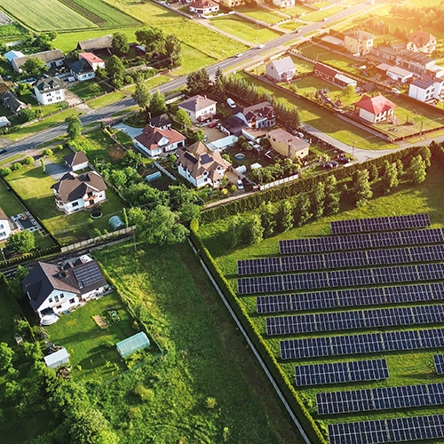 Aerial view of a community and the solar panels they run